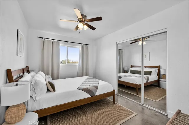 a bedroom with a bed and window