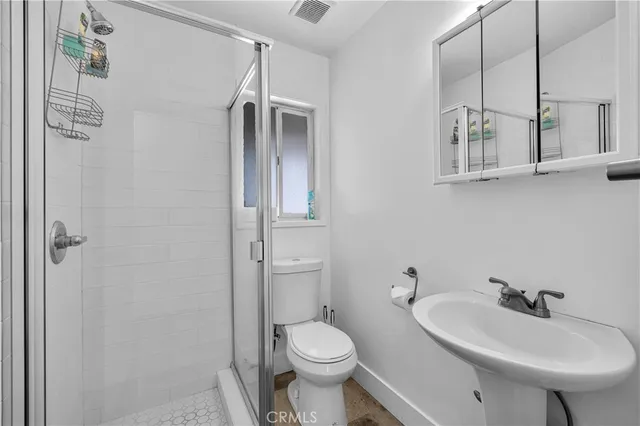 a bathroom with a sink toilet and mirror