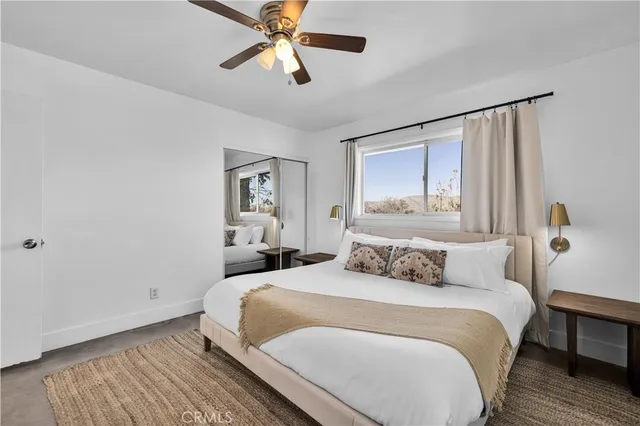 a bedroom with a large bed and a chandelier