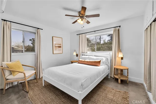 a bedroom with a bed and a painting on the wall