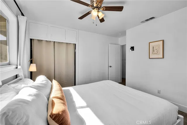 a bedroom with a bed and window