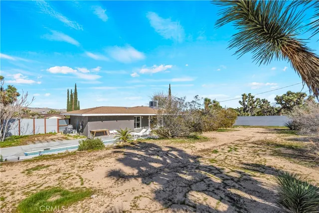 a front view of a house with garden space and patio