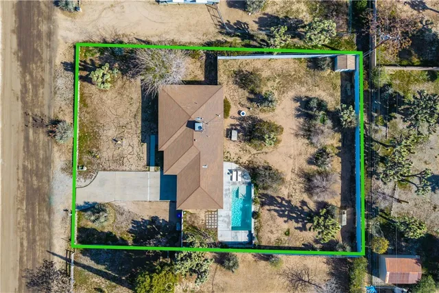 an aerial view of a house with a yard and garden