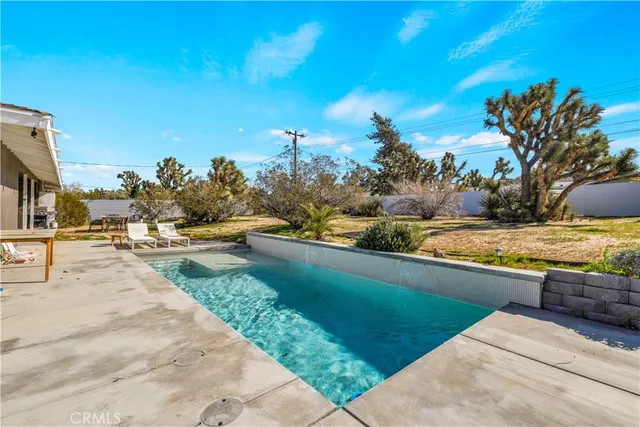a view of swimming pool with a yard