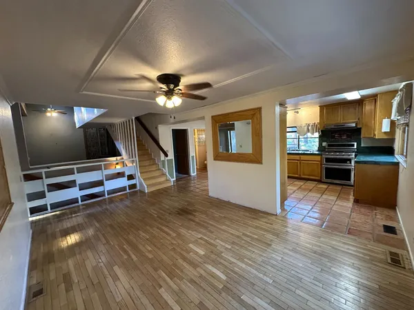 a kitchen with stainless steel appliances granite countertop a stove a sink and a refrigerator