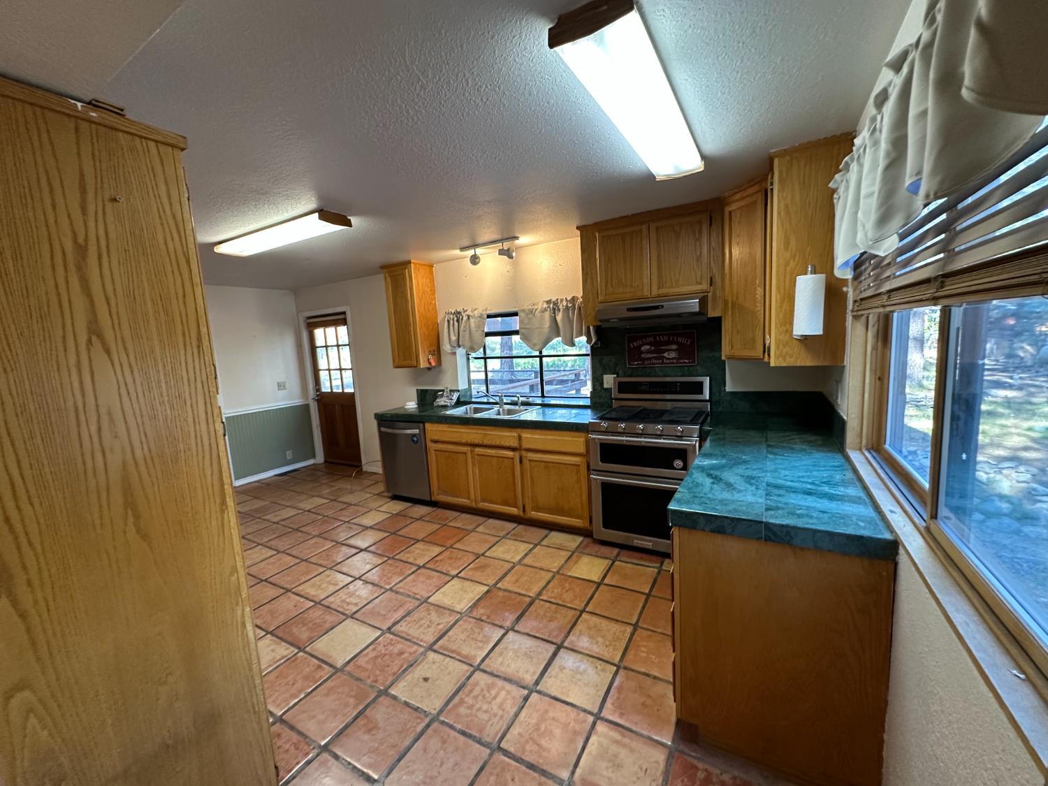 878 Rheinfelder Street Portola, CA 96122 - Photo 15 of 36 a kitchen with stainless steel appliances granite countertop a stove a sink and a refrigerator