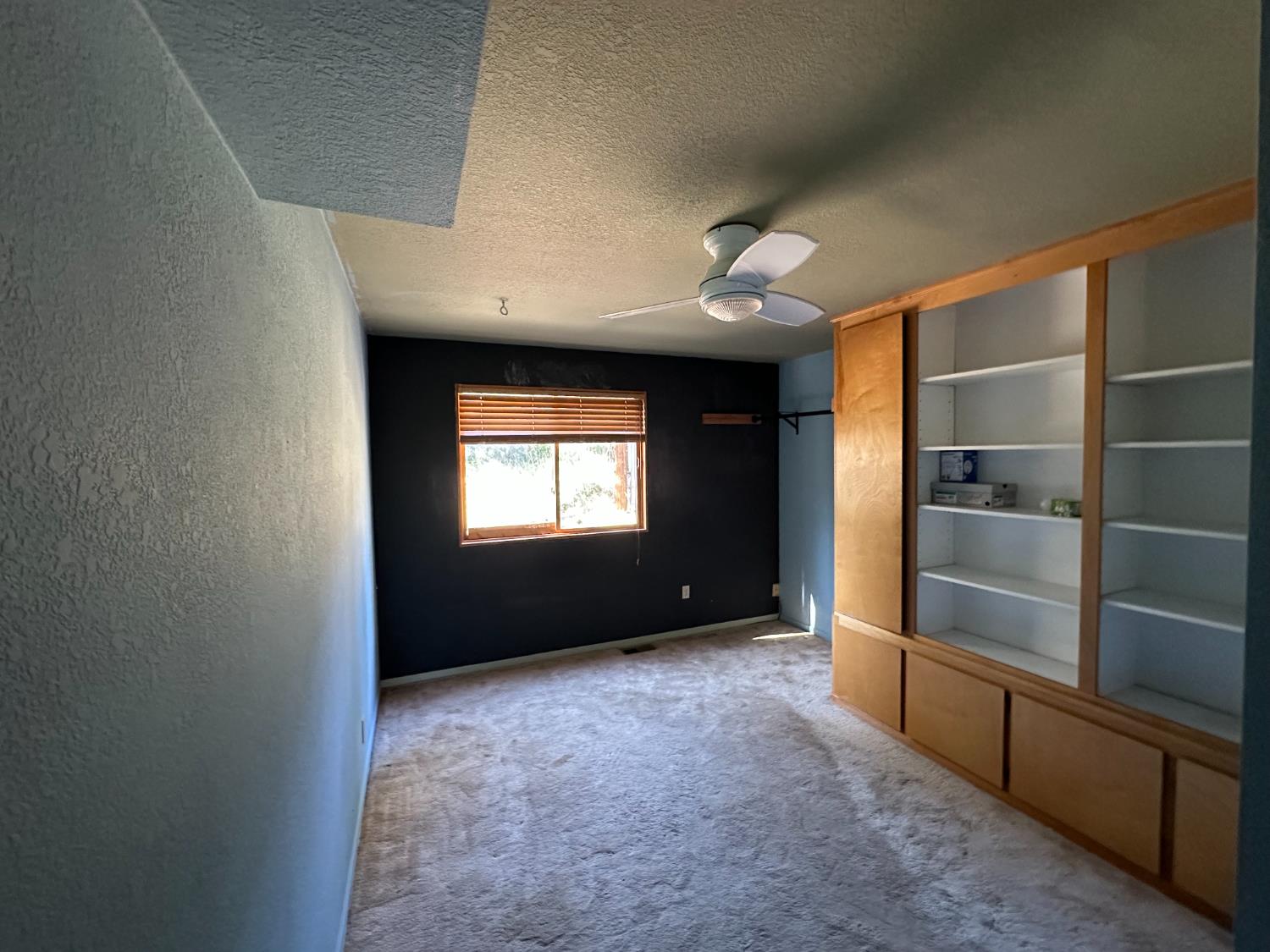 878 Rheinfelder Street Portola, CA 96122 - Photo 20 of 36 a view of empty room with a fireplace and window