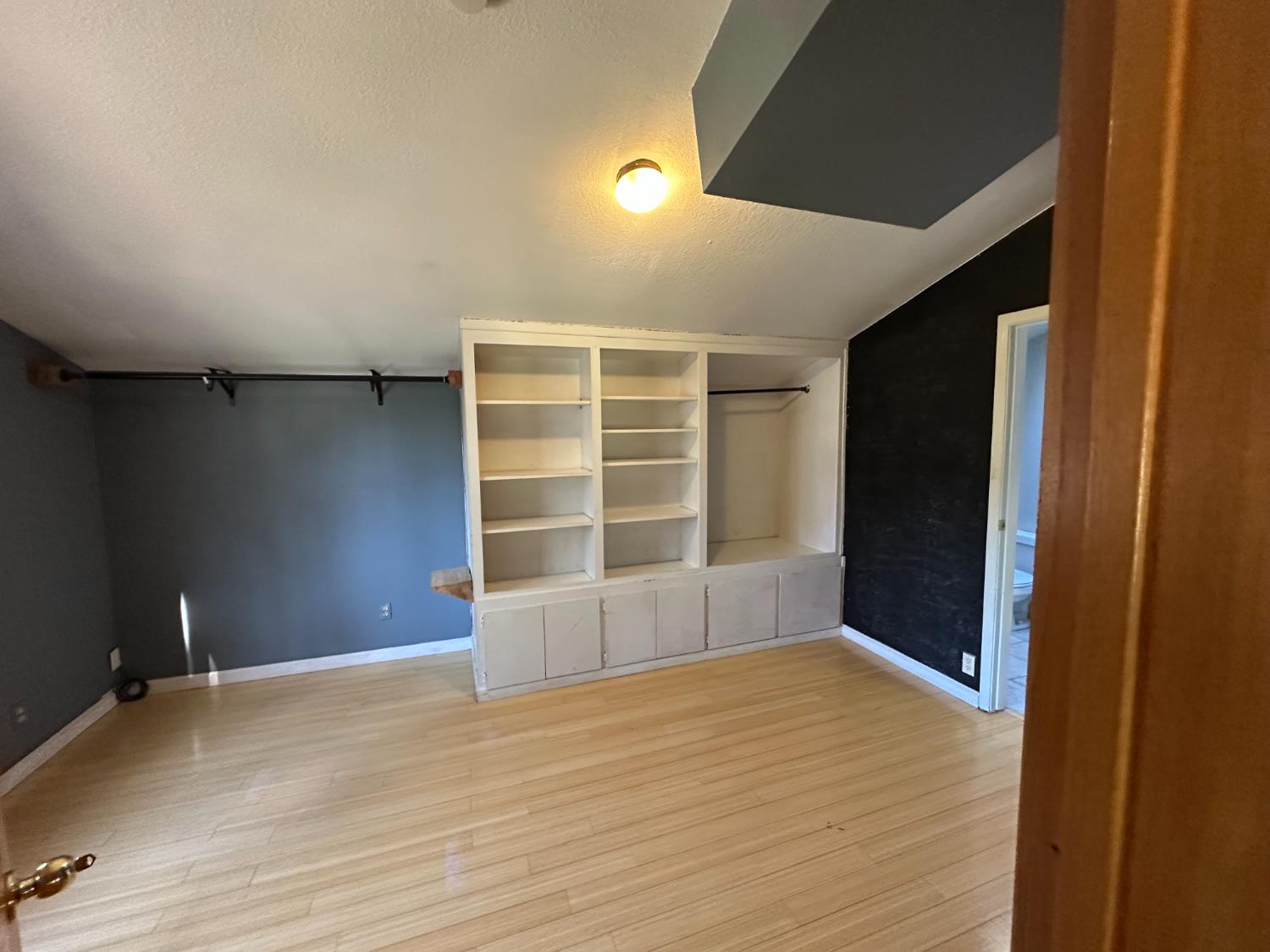 878 Rheinfelder Street Portola, CA 96122 - Photo 23 of 36 a view of an empty room with a window and wooden floor