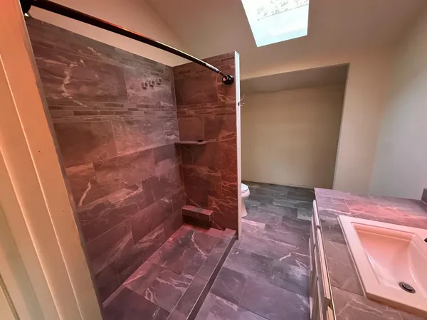 a bedroom with a bed and a shower