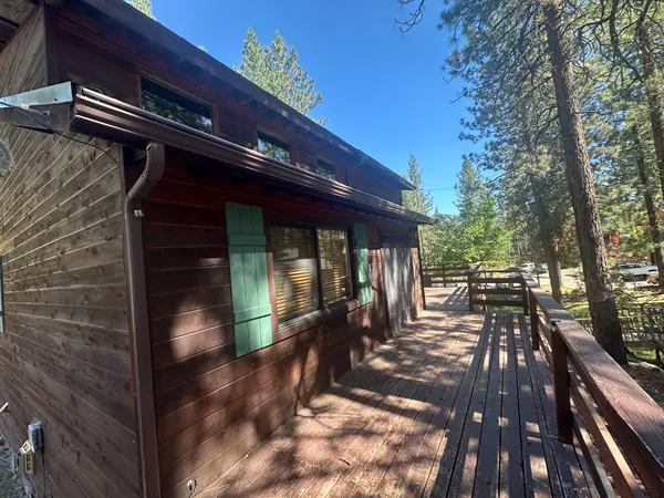 a view of outdoor space with deck and tree