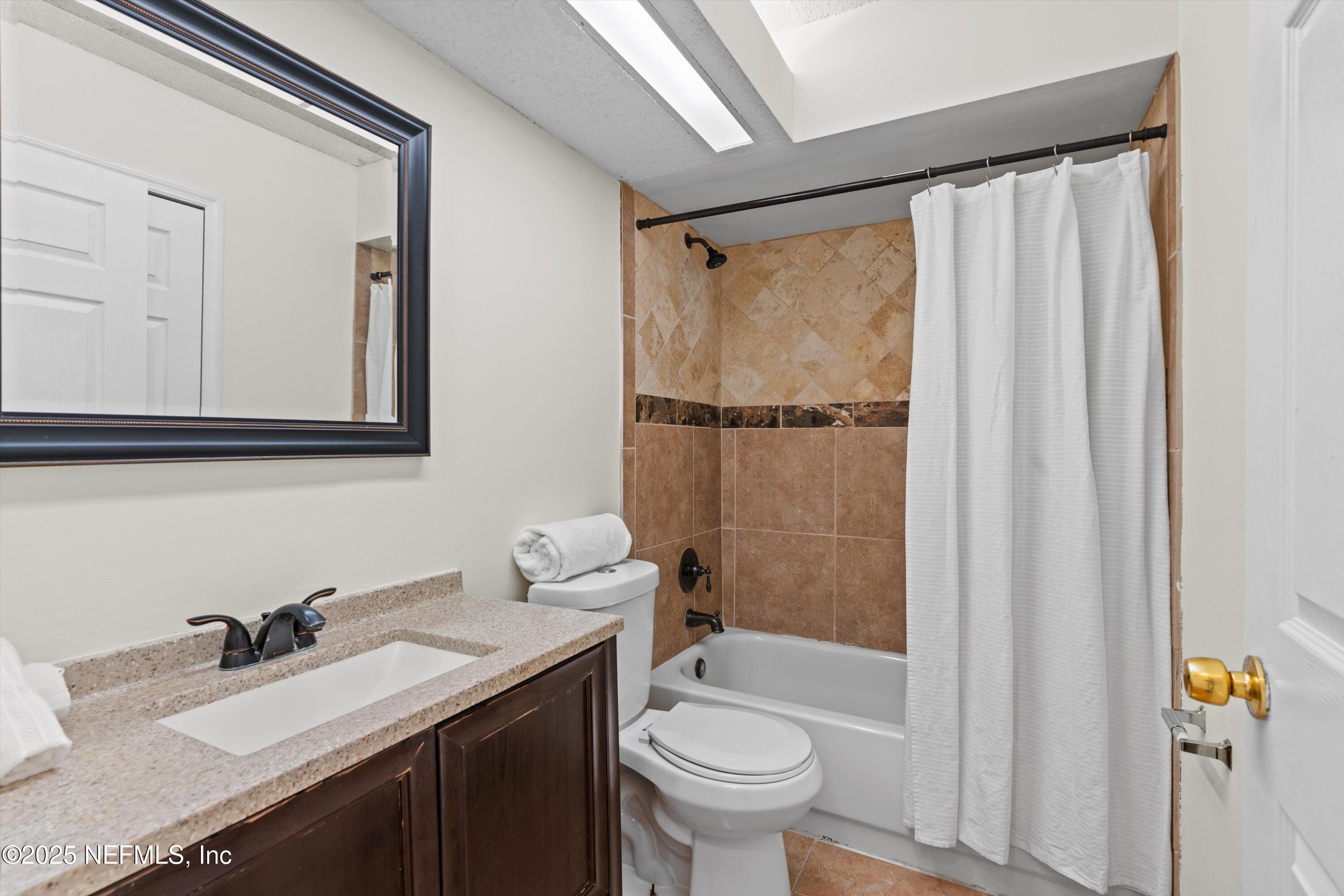 10713 Rutgers Road Jacksonville, FL 32218 - Photo 10 of 26 a bathroom with a sink toilet and shower