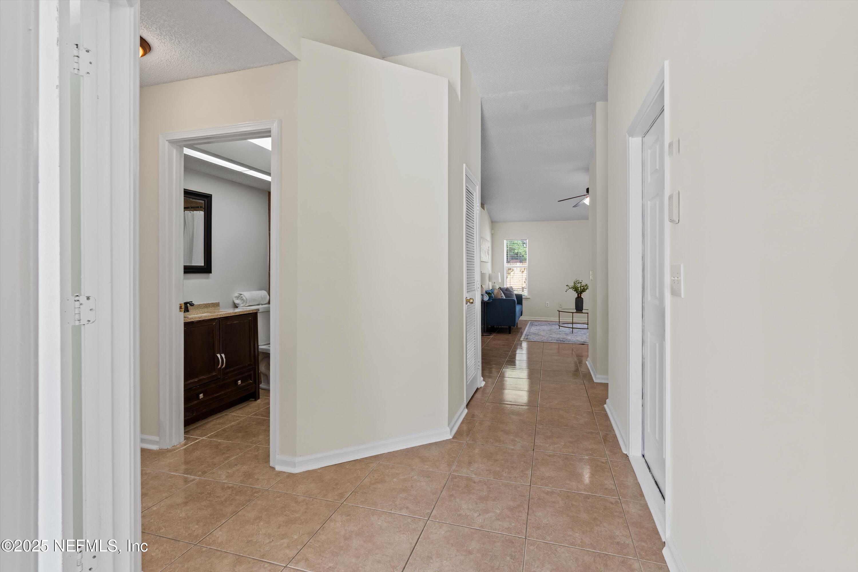 10713 Rutgers Road Jacksonville, FL 32218 - Photo 12 of 26 a view of a hallway with wooden shelves