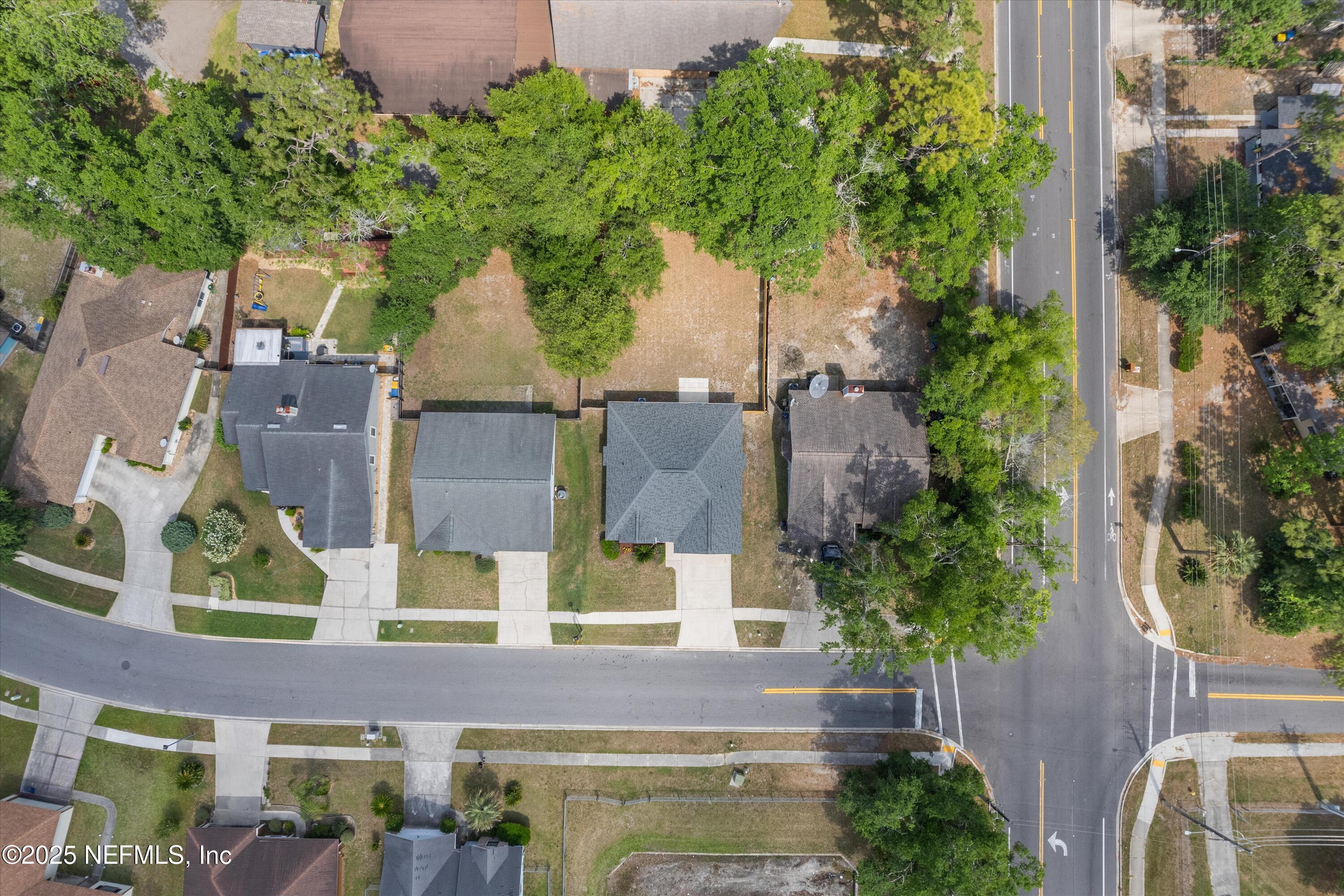 10713 Rutgers Road Jacksonville, FL 32218 - Photo 24 of 26 an aerial view of a house with swimming pool and large trees