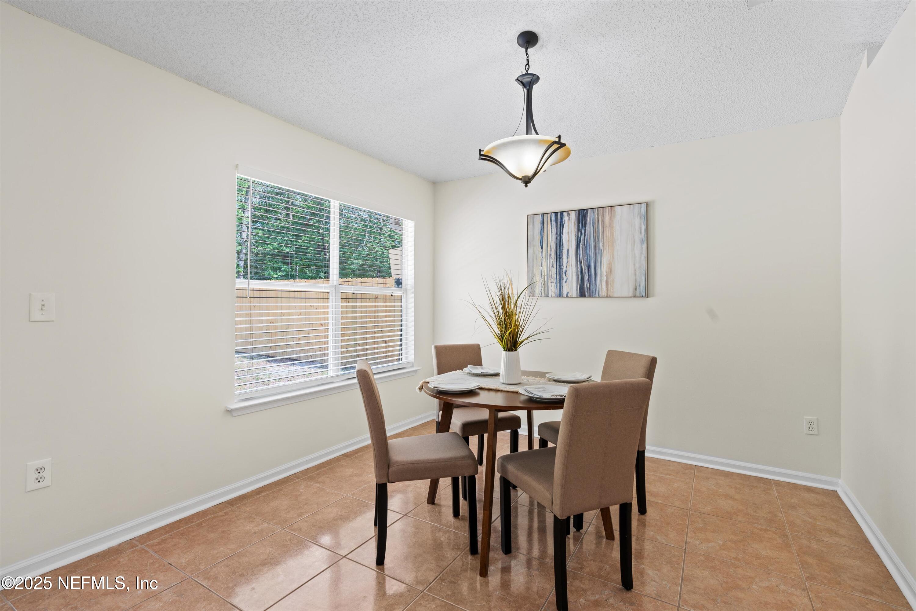 10713 Rutgers Road Jacksonville, FL 32218 - Photo 4 of 26 a view of a dining room with furniture window and outside view