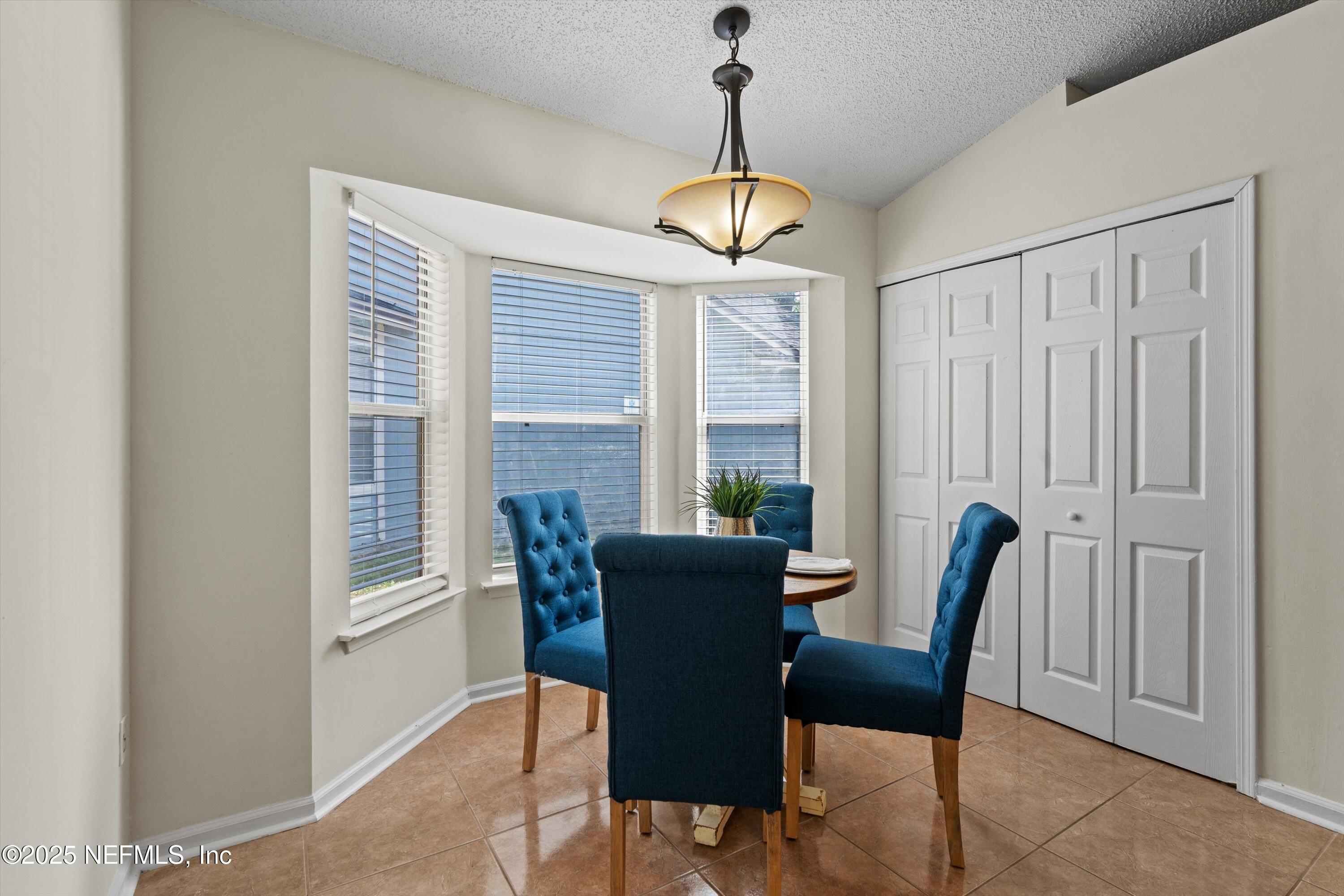10713 Rutgers Road Jacksonville, FL 32218 - Photo 6 of 26 a view of a dining room with furniture window and outside view
