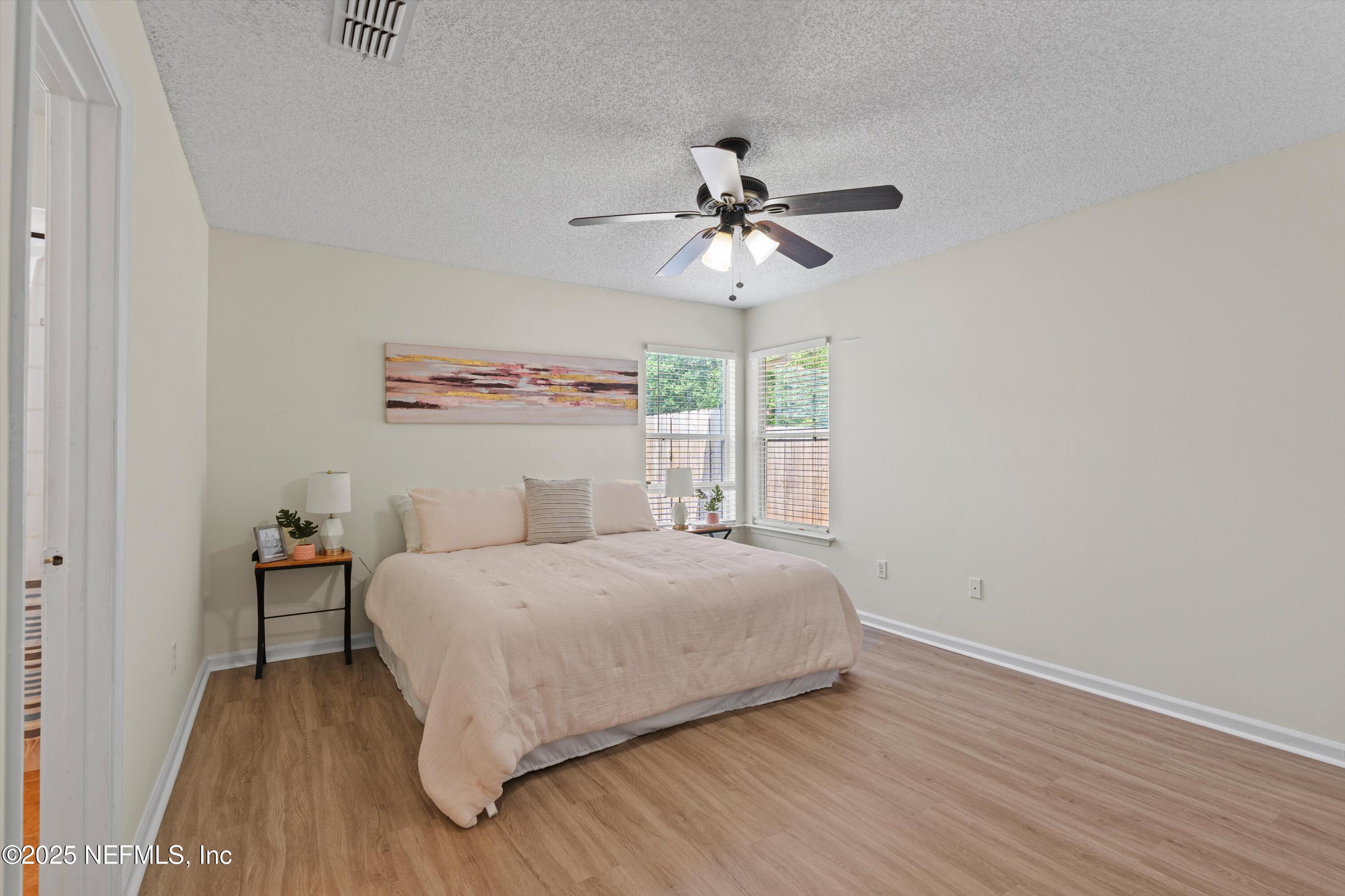 10713 Rutgers Road Jacksonville, FL 32218 - Photo 7 of 26 a bedroom with a bed and a window