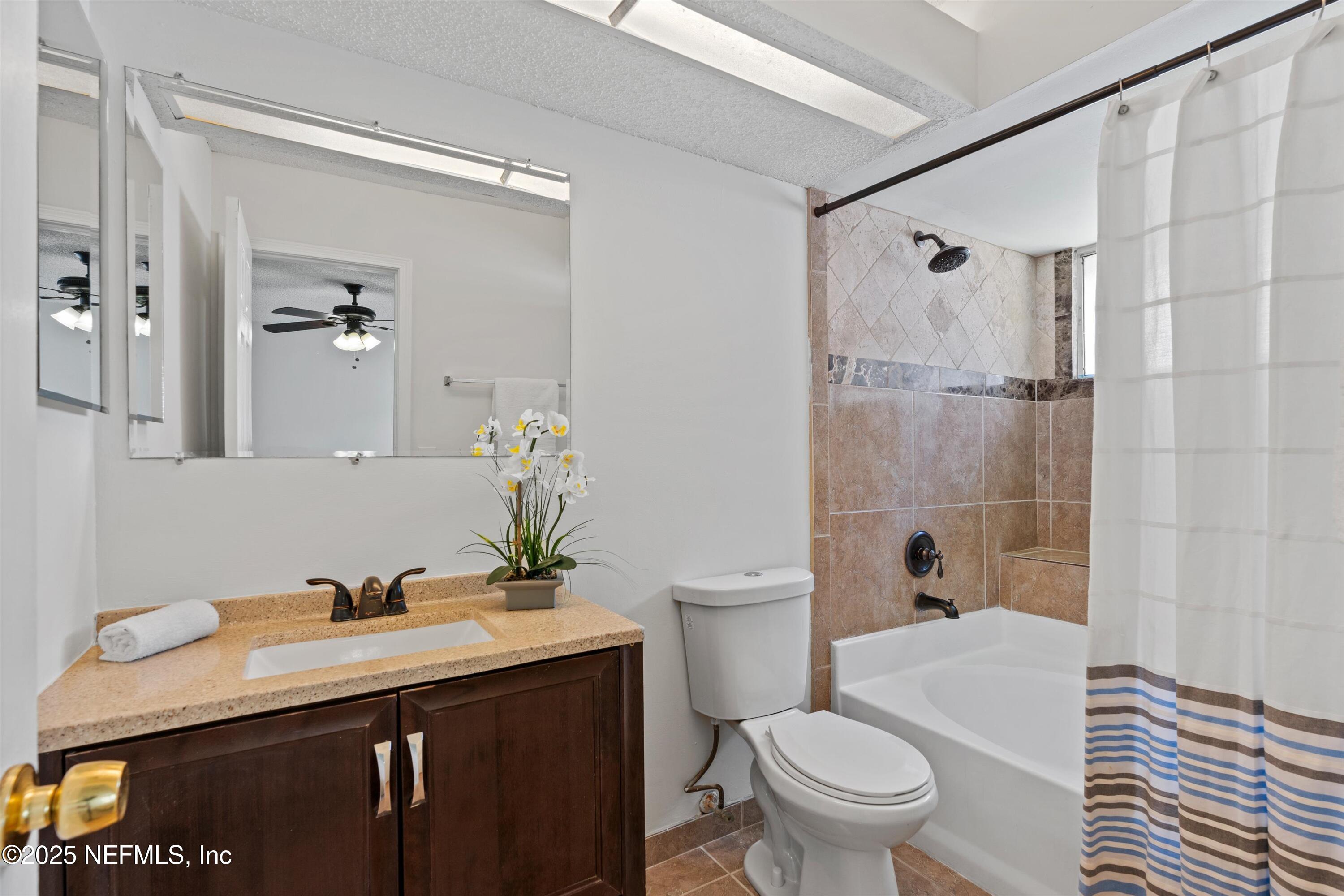 10713 Rutgers Road Jacksonville, FL 32218 - Photo 8 of 26 a bathroom with a sink a toilet and shower