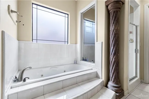 a bathroom with a bathtub and a shower