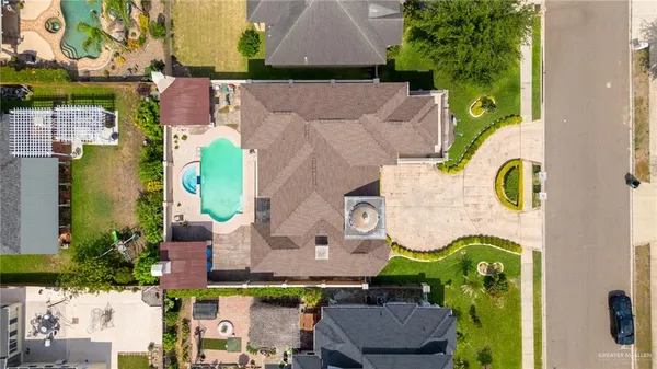 an aerial view of residential house with outdoor space and swimming pool