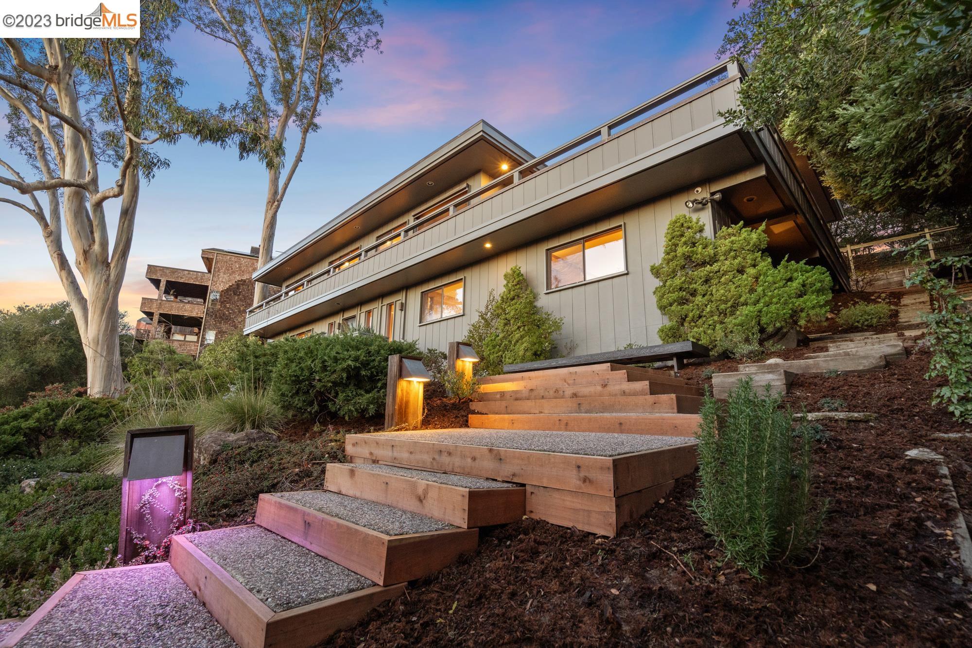 a view of a patio with couches table and chairs and potted plants