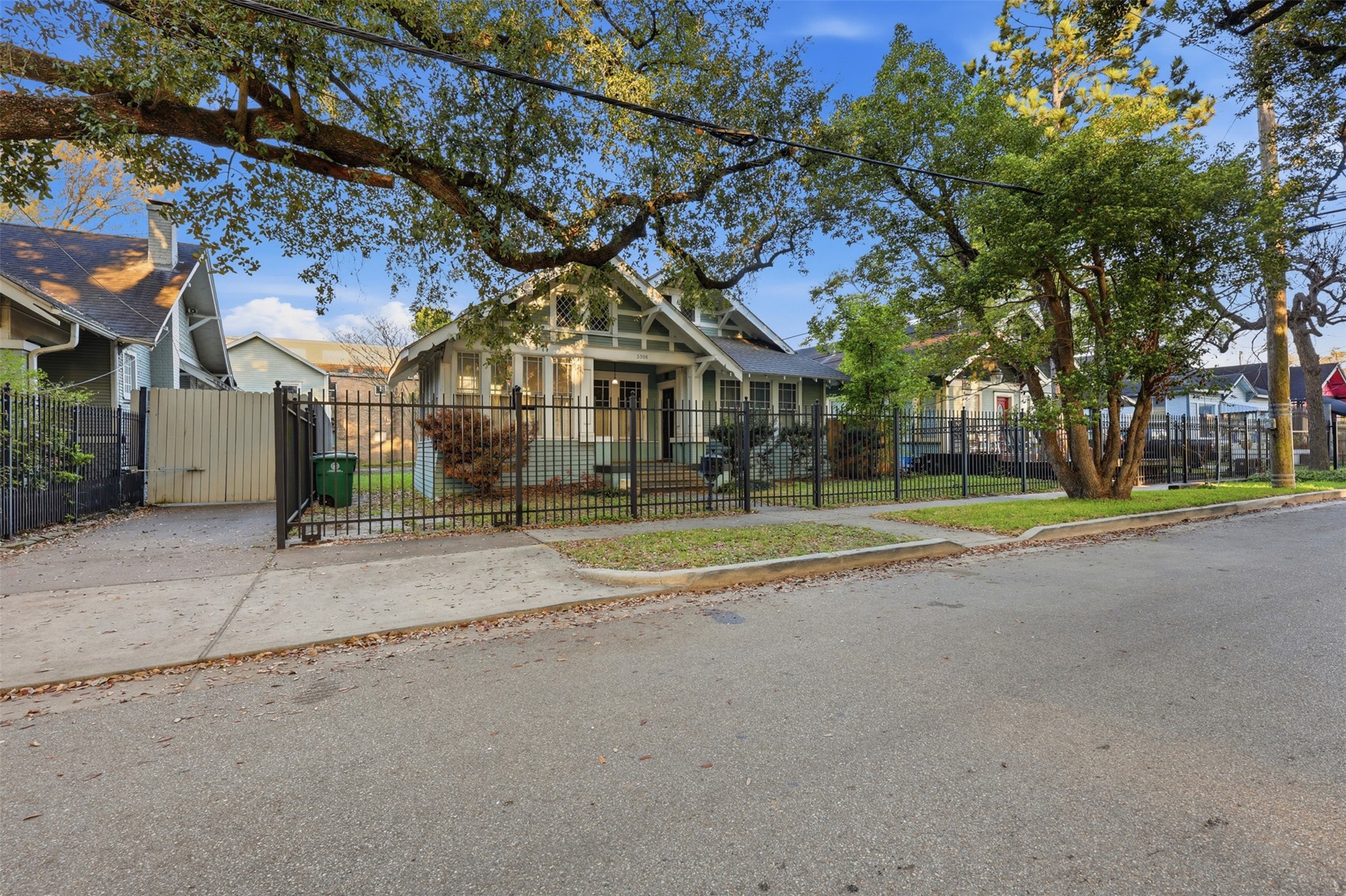 3308 Yupon Street Houston, TX 77006 - Photo 5 of 20 a view of a white house with a big yard and large trees