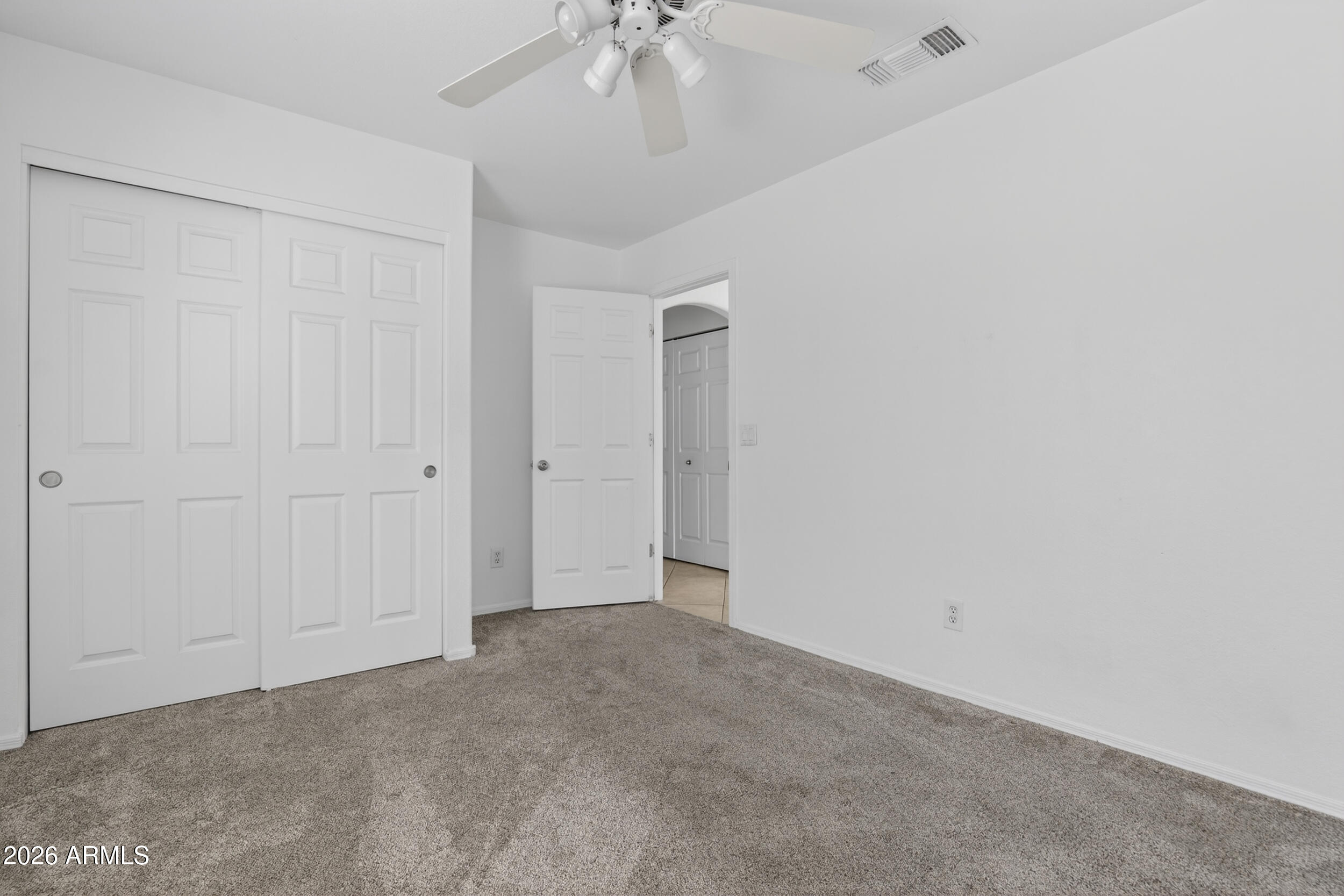 1363 East Butler Circle Chandler, AZ 85225 - Photo 30 of 41 an empty room with a chandelier fan