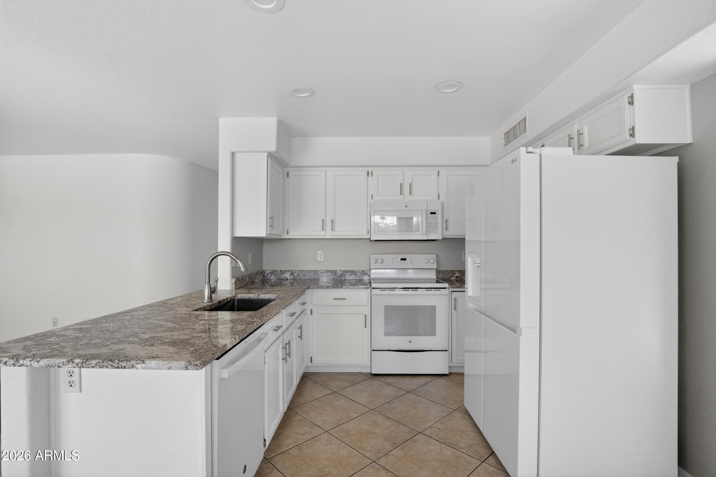 1363 East Butler Circle Chandler, AZ 85225 - Photo 9 of 41 a kitchen with a sink a stove and refrigerator