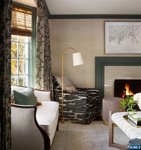 a living room with furniture a fireplace and a large window