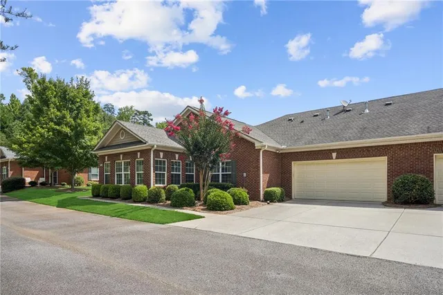 a living room with furniture a flat screen tv and a window