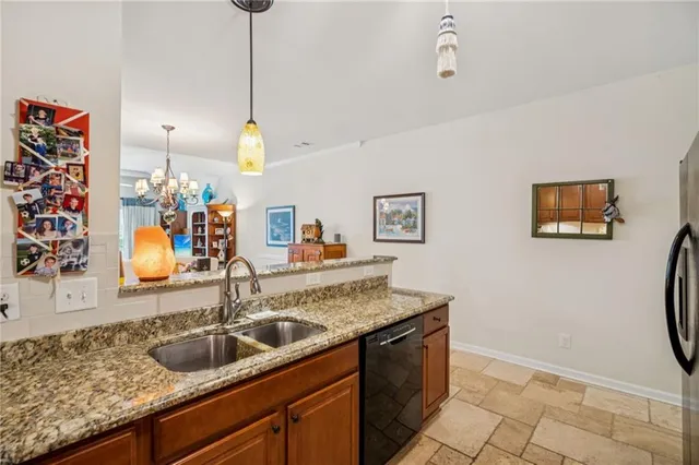 a kitchen with stainless steel appliances granite countertop a stove and a refrigerator
