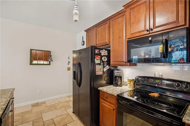 a bedroom with a bed and a flat tv screen on the dresser