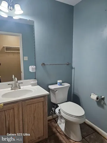 a bathroom with a toilet a sink and mirror