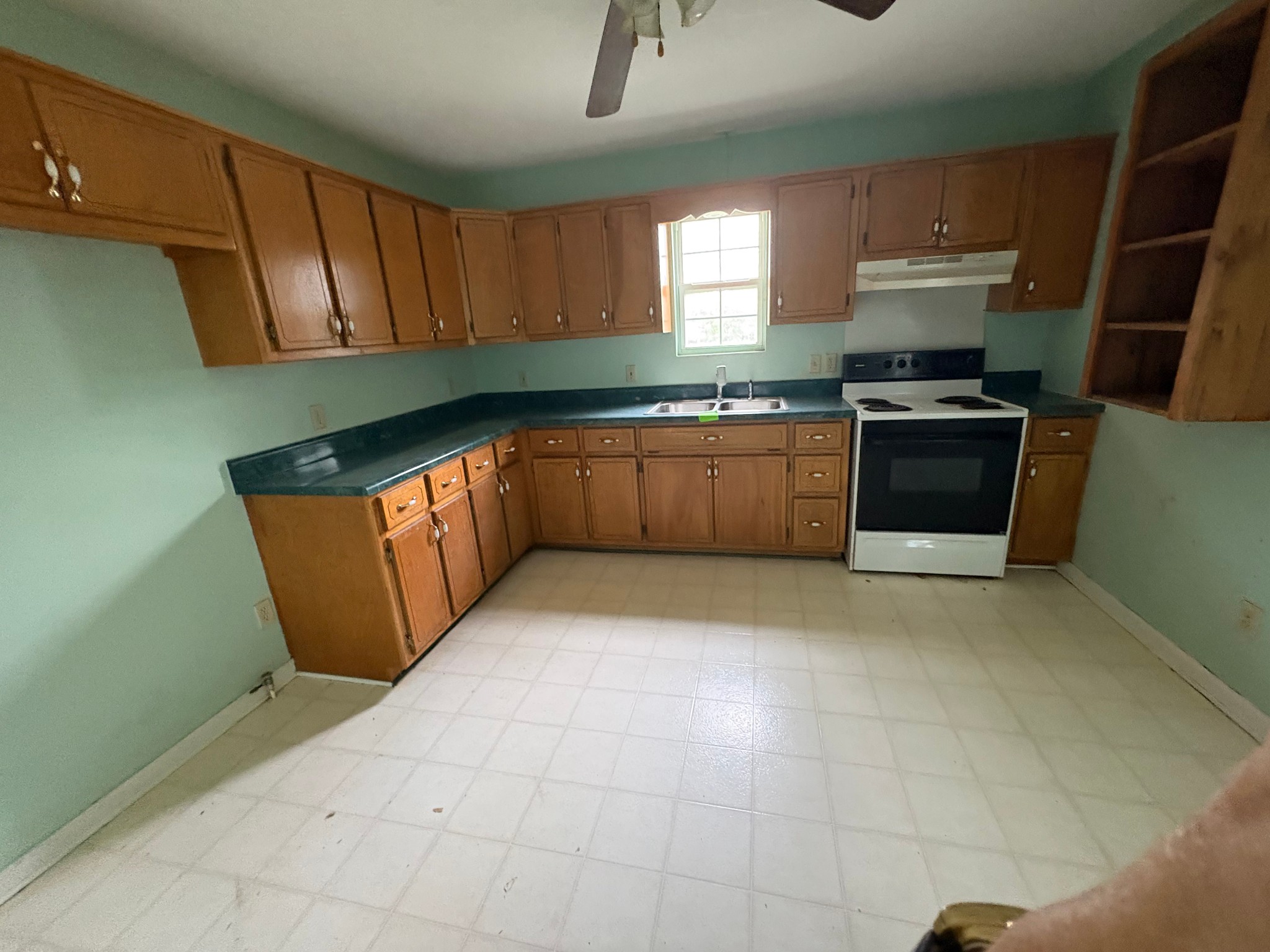 2174 Pleasant Hill Road Lynchburg, TN 37352 - Photo 9 of 16 a kitchen with granite countertop a sink a stove a microwave and cabinets