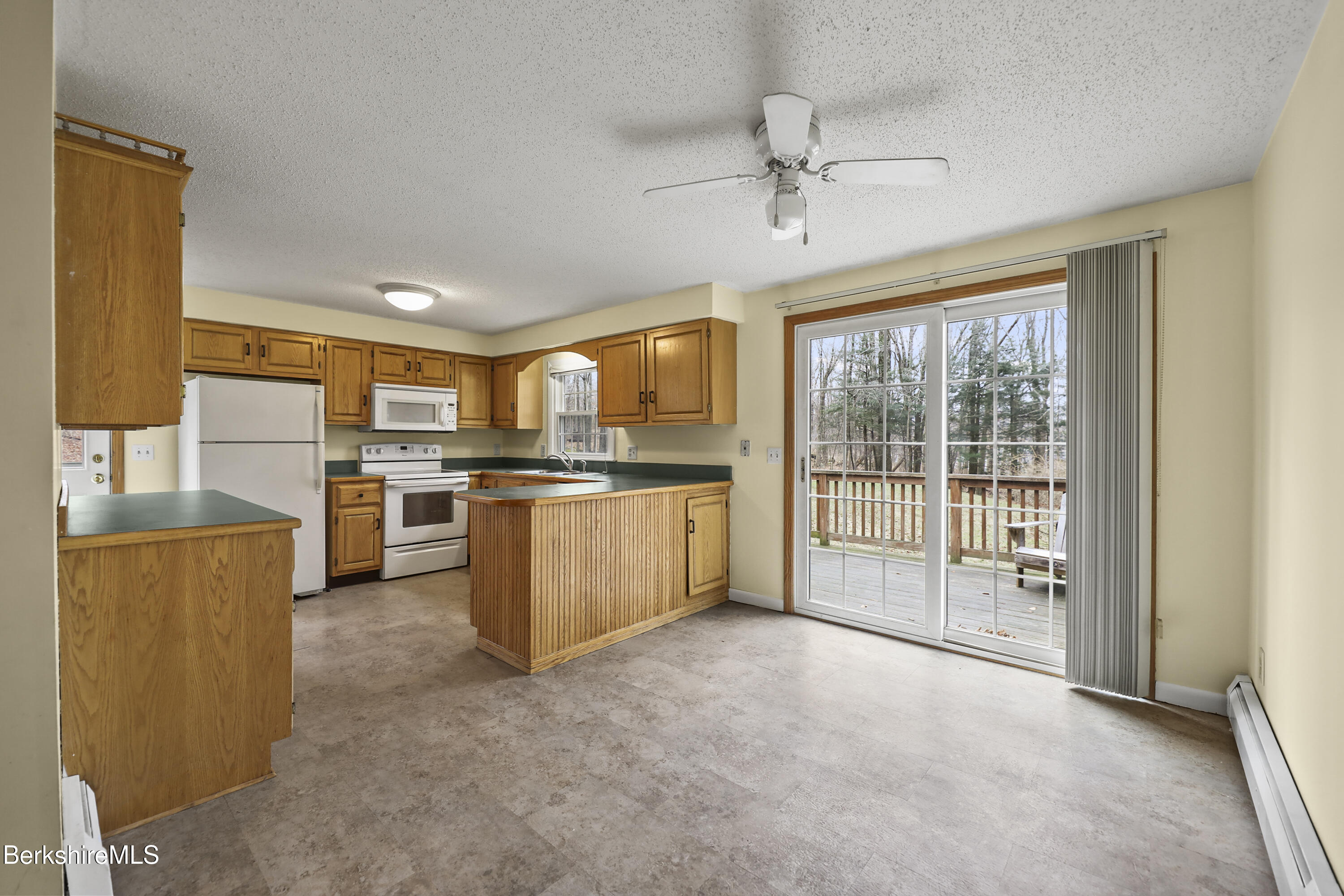 2271 Jacobs Ladder Road Becket, MA 01223 - Photo 11 of 28 a open kitchen with stainless steel appliances granite countertop a stove top oven a sink and a refrigerator