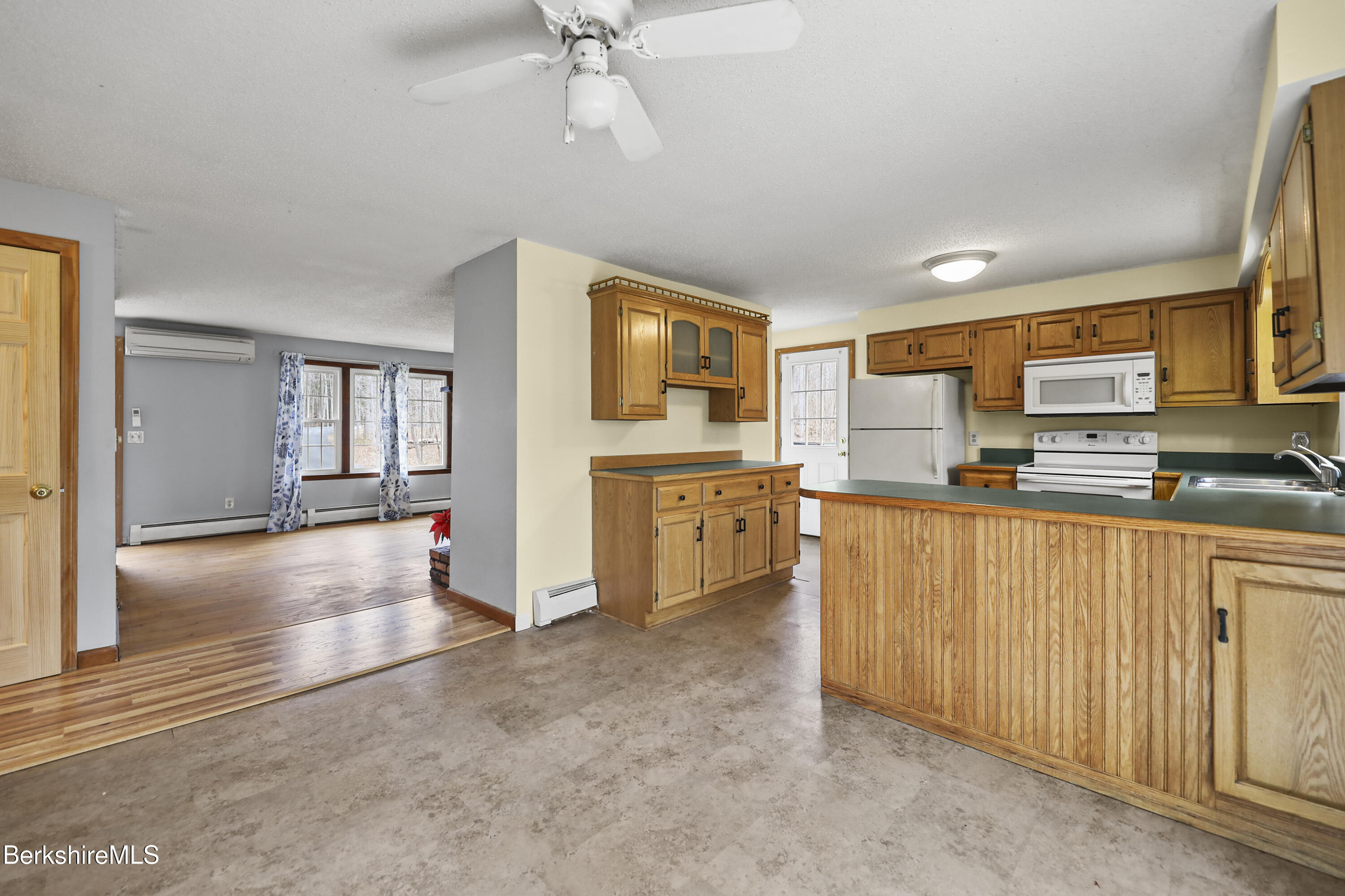 2271 Jacobs Ladder Road Becket, MA 01223 - Photo 12 of 28 a kitchen with stainless steel appliances a stove top oven a sink a refrigerator and cabinets