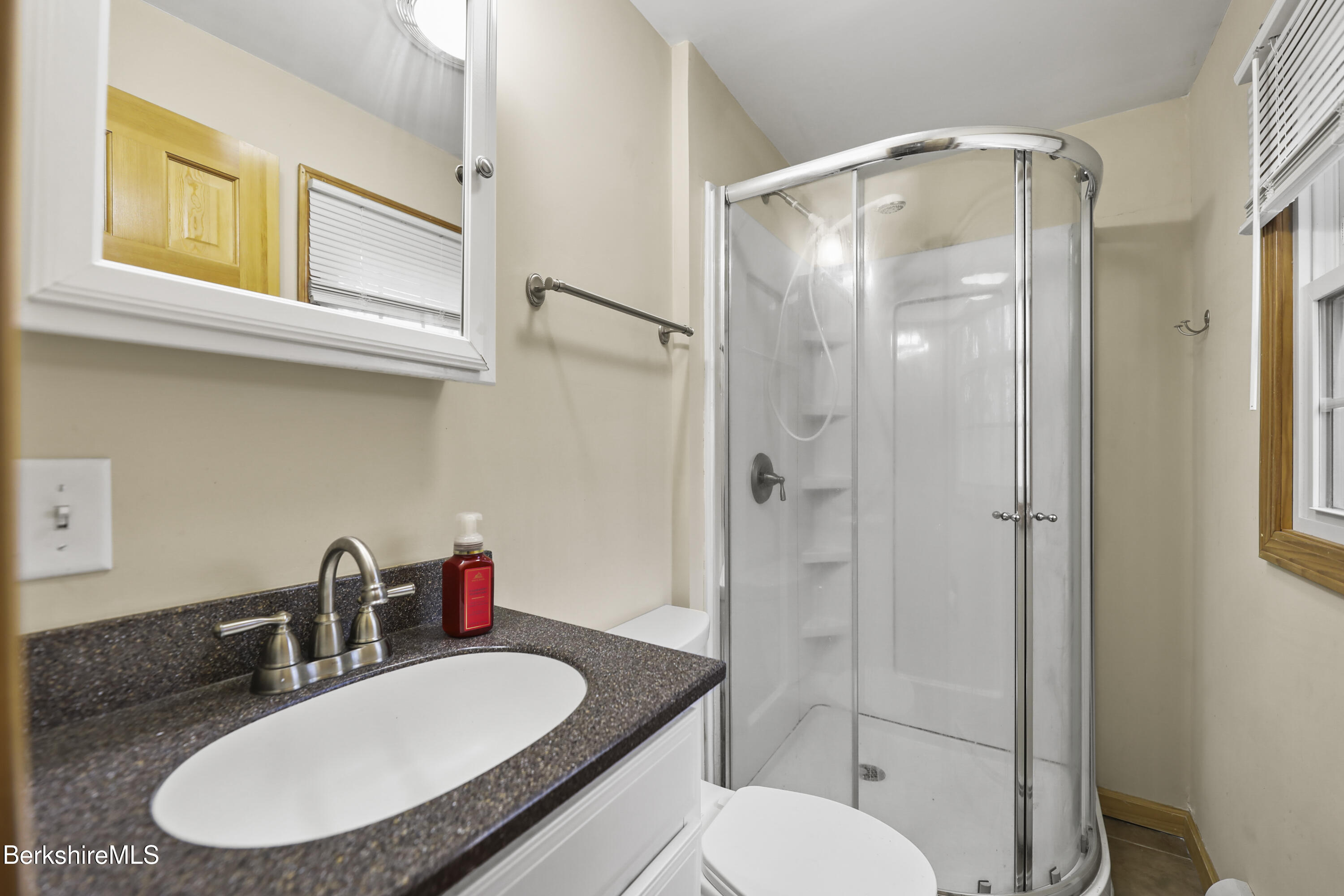 2271 Jacobs Ladder Road Becket, MA 01223 - Photo 14 of 28 a bathroom with a granite countertop toilet sink and shower
