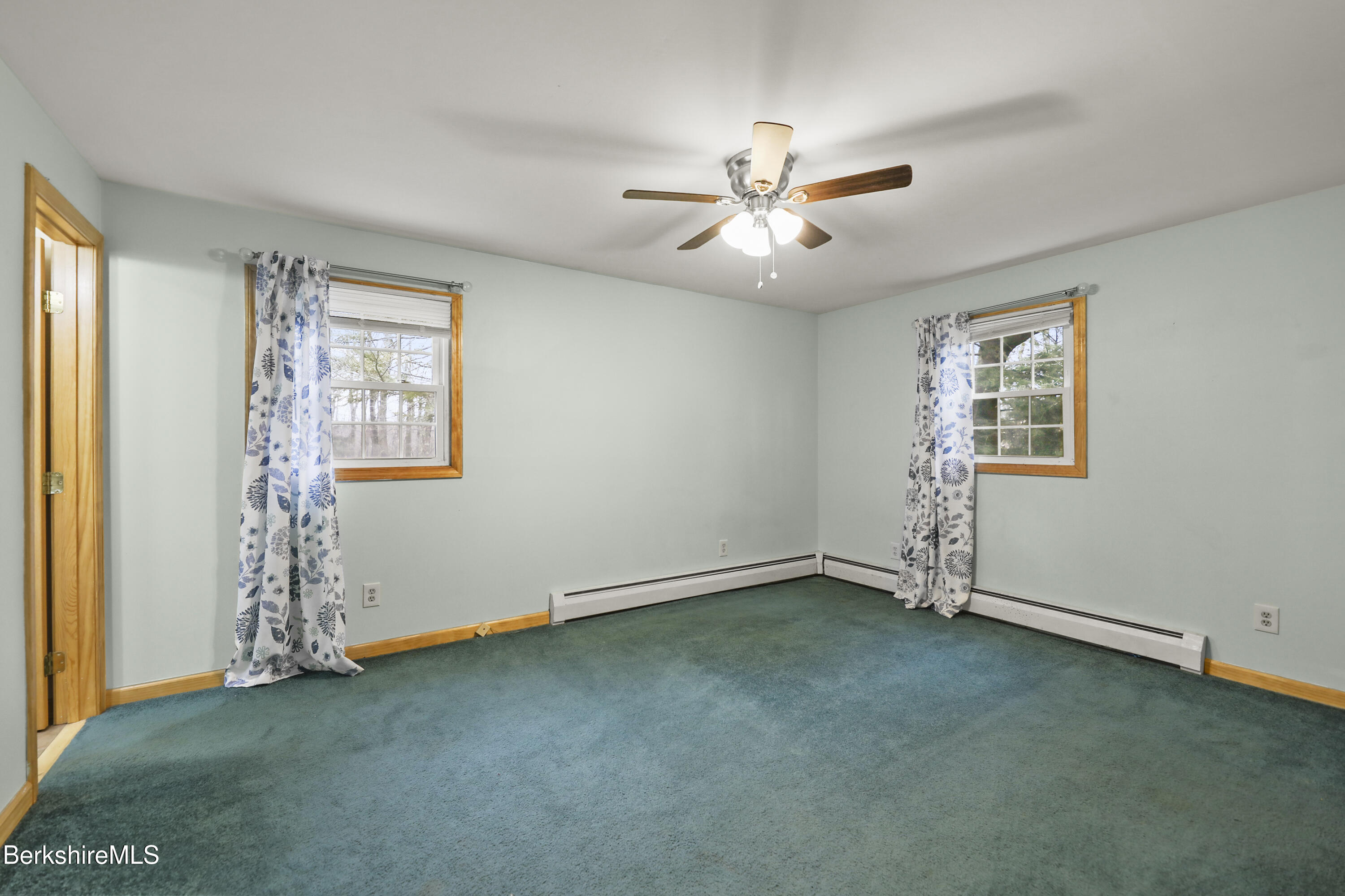 2271 Jacobs Ladder Road Becket, MA 01223 - Photo 18 of 28 an empty room with windows and fan