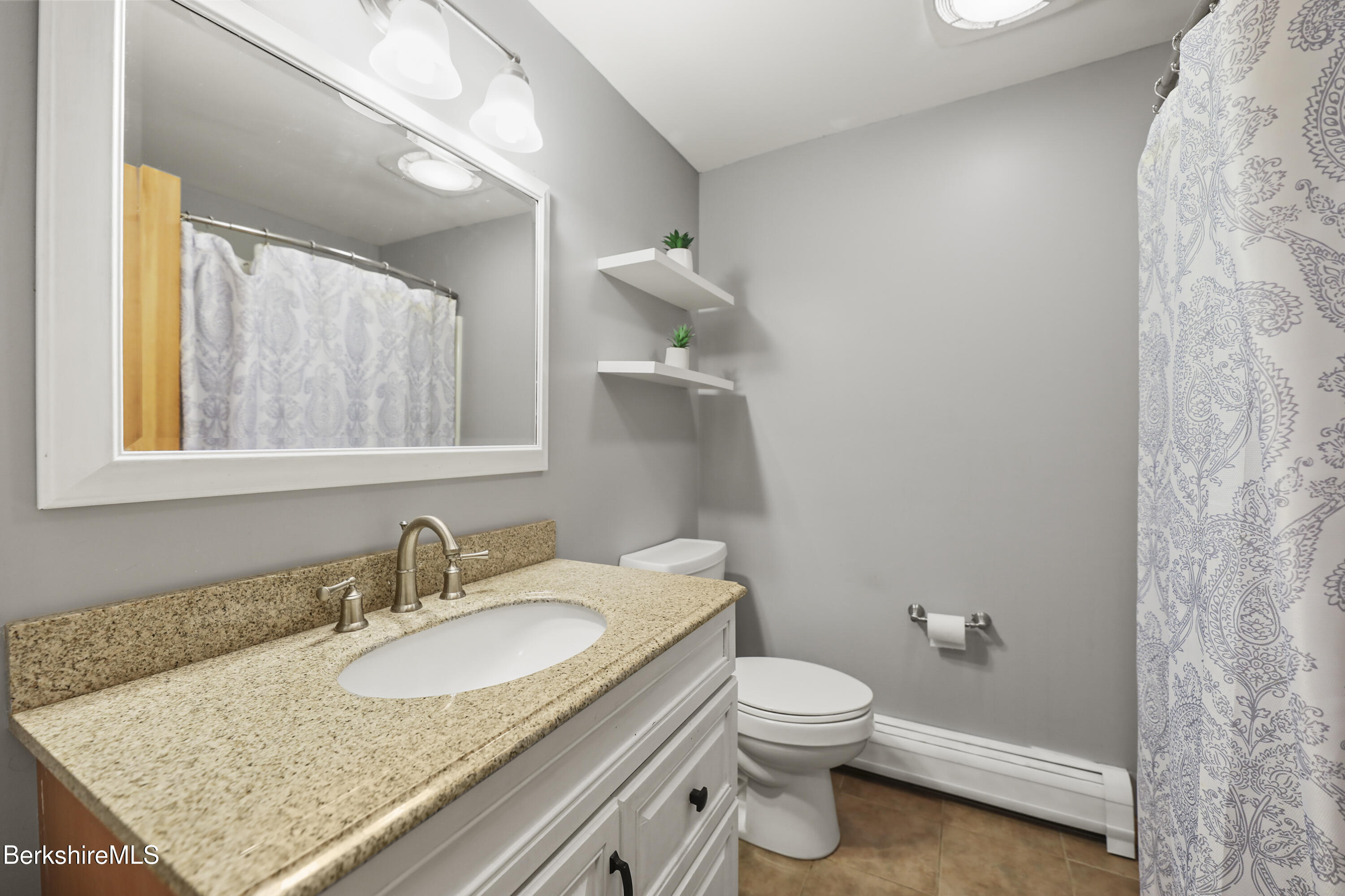 2271 Jacobs Ladder Road Becket, MA 01223 - Photo 19 of 28 a bathroom with a granite countertop sink a toilet and a mirror