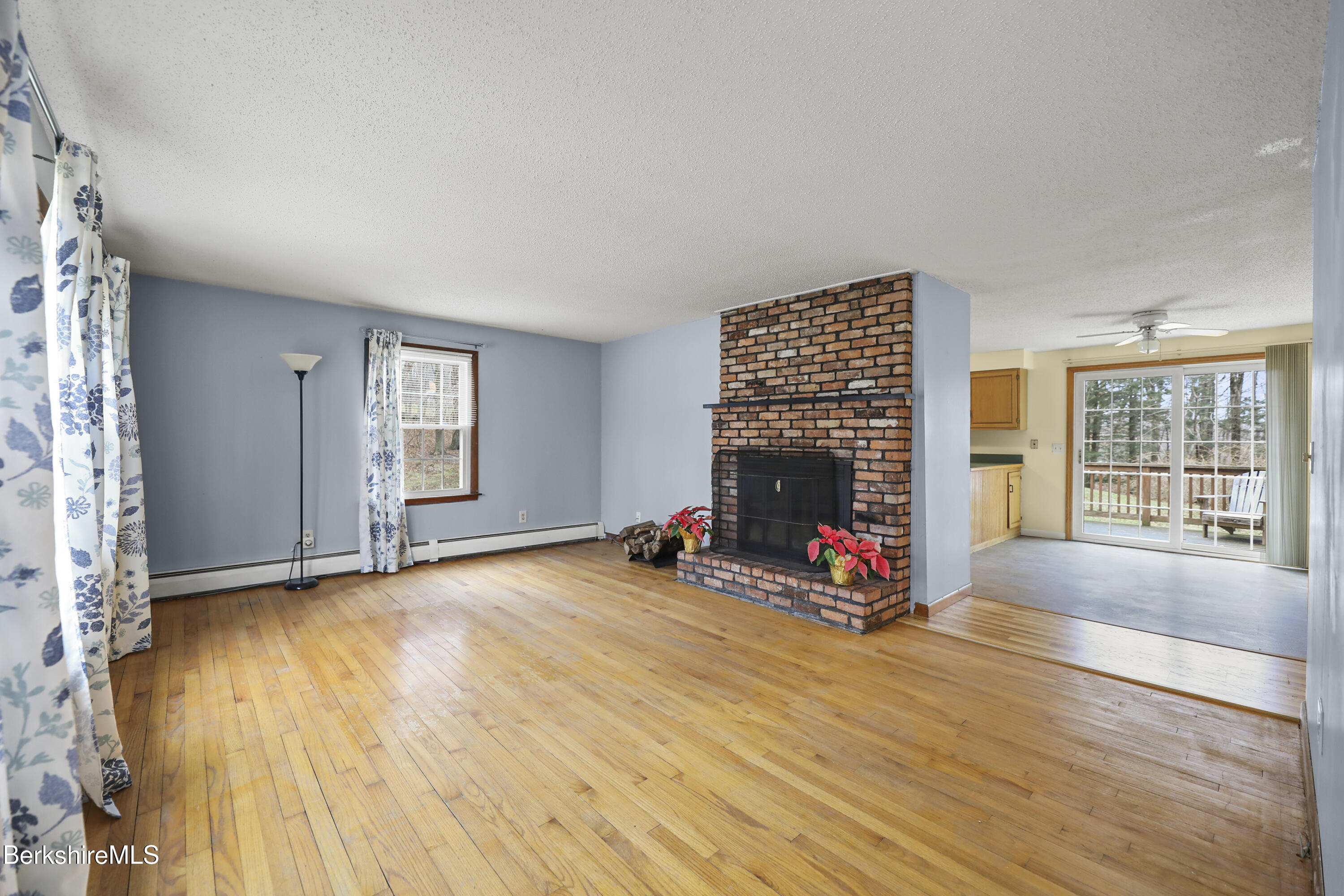 2271 Jacobs Ladder Road Becket, MA 01223 - Photo 5 of 28 a view of a livingroom with wooden floor and a fireplace