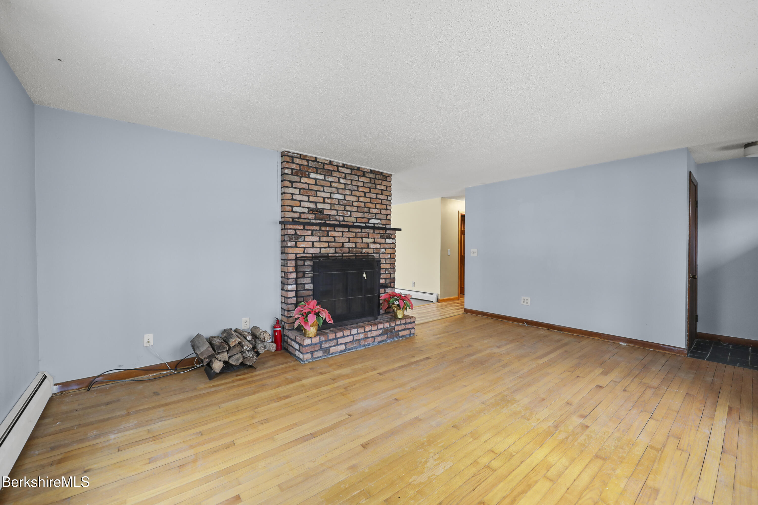 2271 Jacobs Ladder Road Becket, MA 01223 - Photo 6 of 28 a view of a room with wooden floor and gym equipment