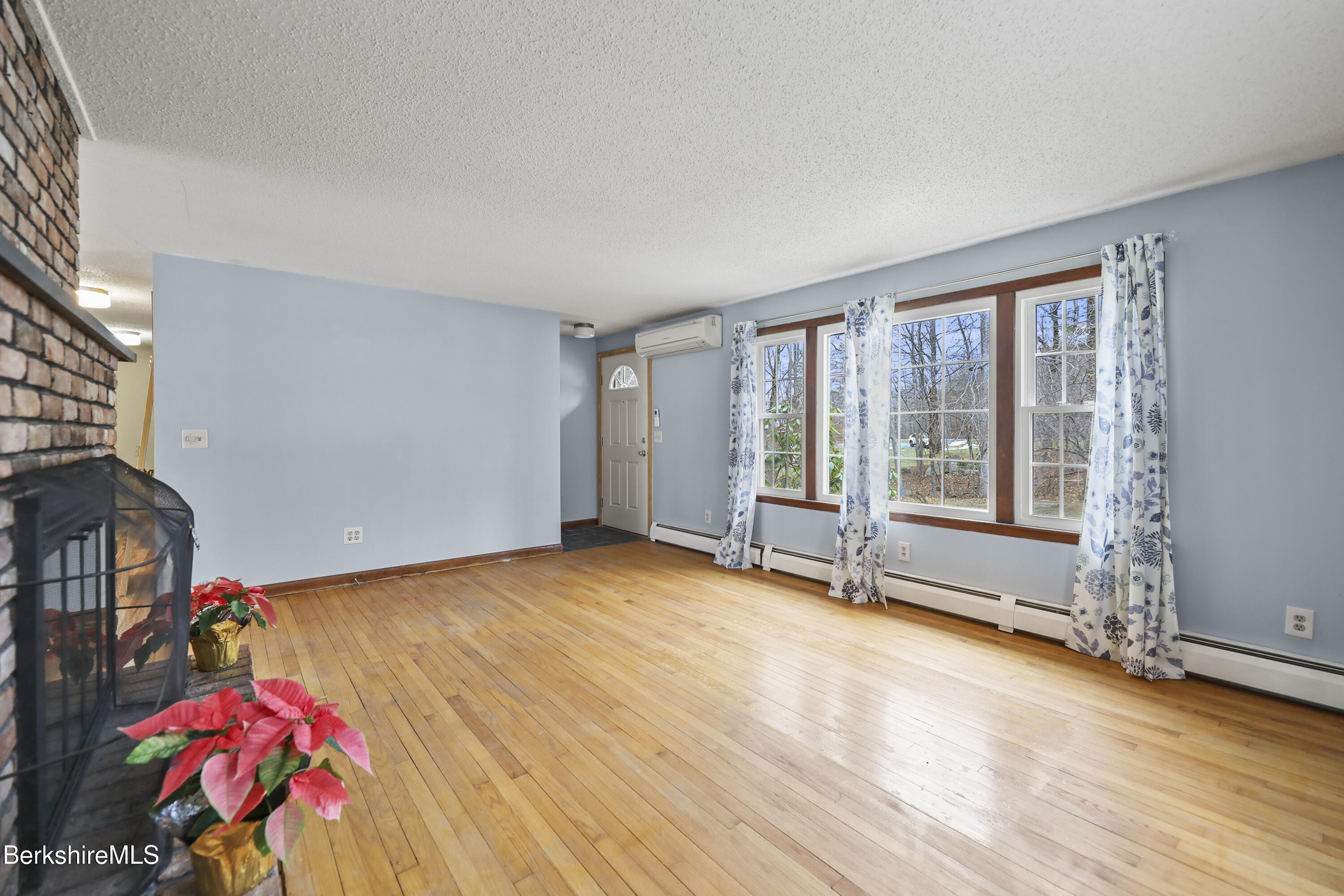 2271 Jacobs Ladder Road Becket, MA 01223 - Photo 7 of 28 an empty room with wooden floor and windows