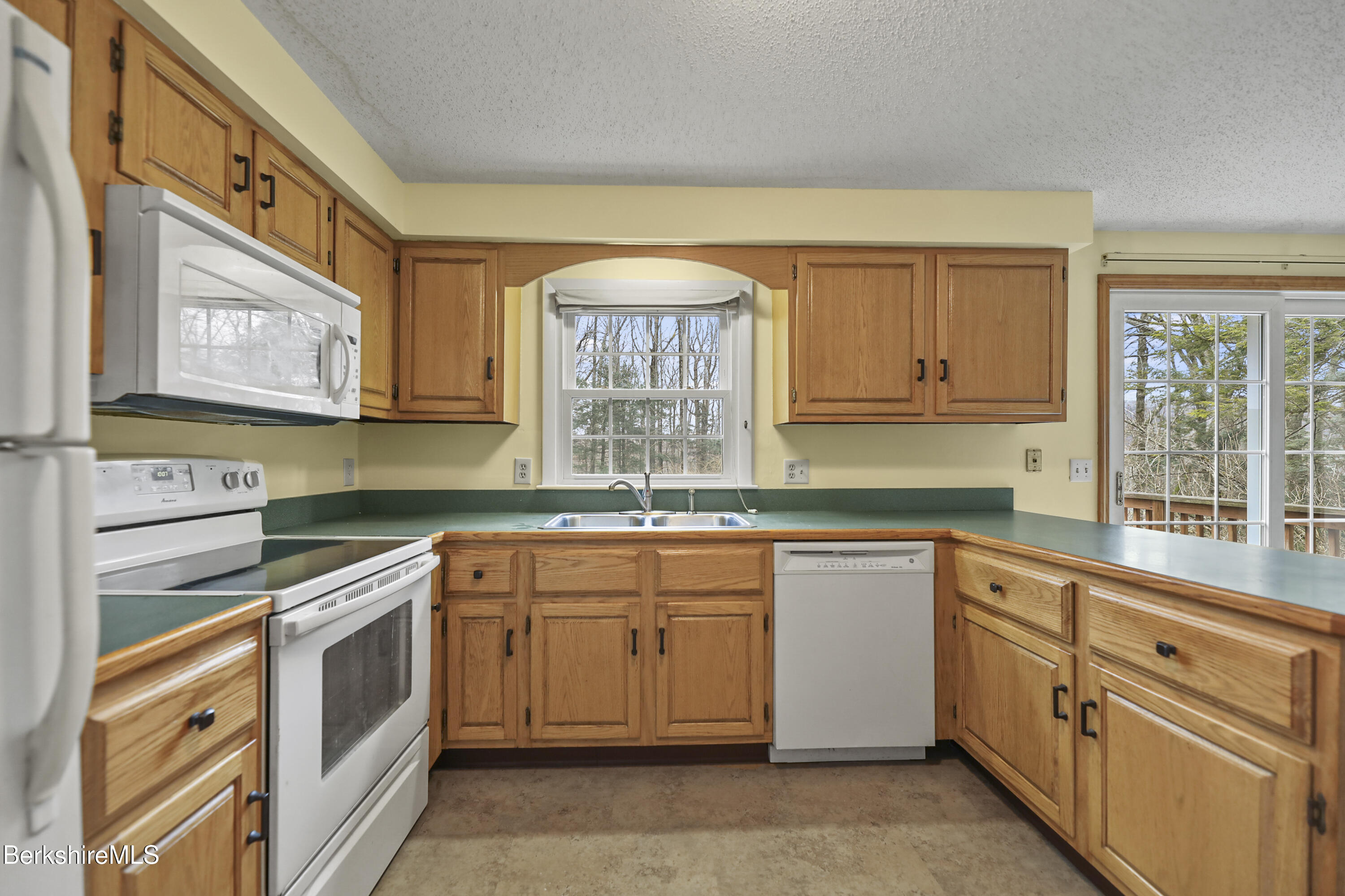 2271 Jacobs Ladder Road Becket, MA 01223 - Photo 8 of 28 a kitchen with white cabinets and white appliances