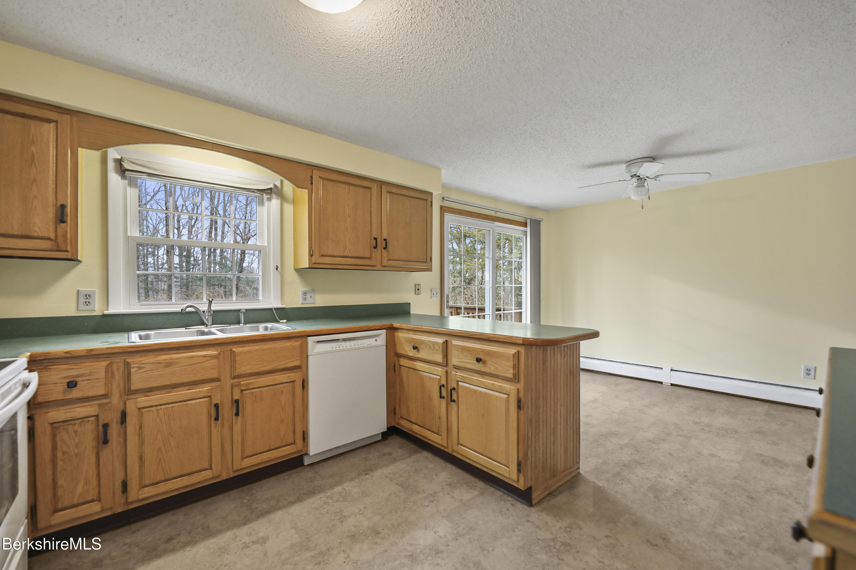 2271 Jacobs Ladder Road Becket, MA 01223 - Photo 9 of 28 a kitchen with granite countertop white cabinets sink and white appliances