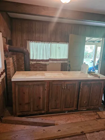 a living room with a bed and a dresser