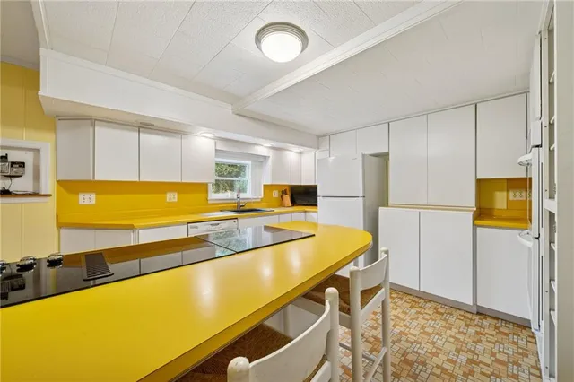 a kitchen with a sink appliances and cabinets