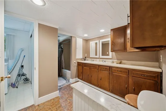 a kitchen with a sink refrigerator and cabinets
