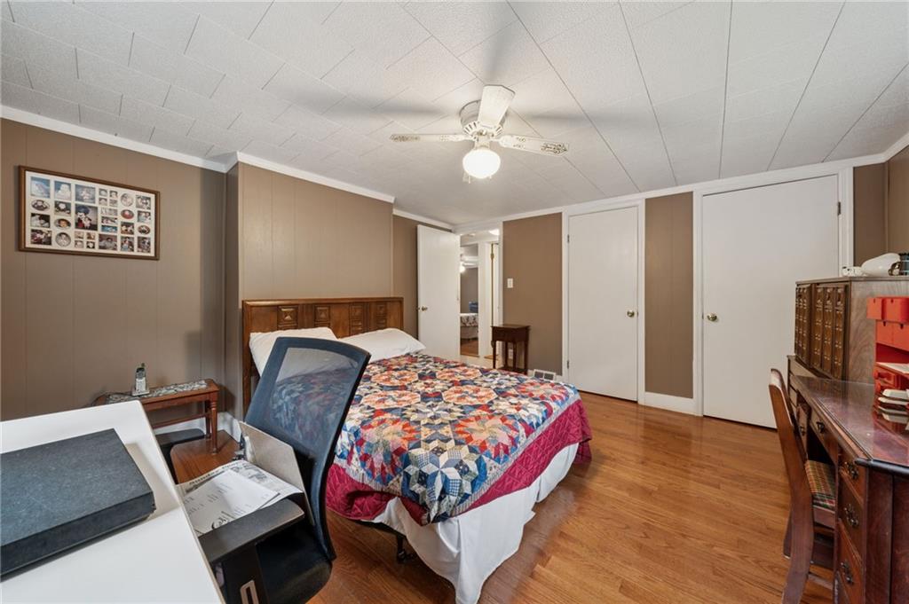 4314 Rostosky Ridge Road Monongahela, PA 15063 - Photo 22 of 38 a bedroom with a bed and a chandelier