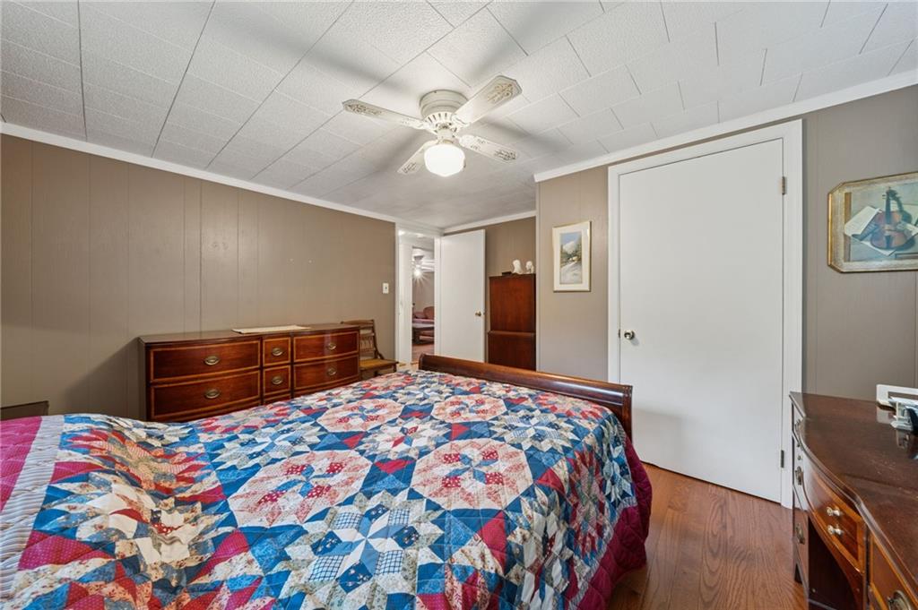 4314 Rostosky Ridge Road Monongahela, PA 15063 - Photo 24 of 38 a bedroom with a bed and a chandelier