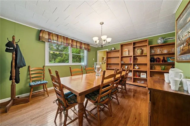 a view of a dining room with furniture and a chandelier