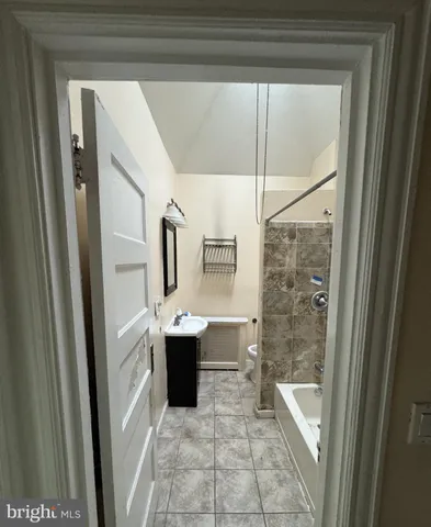 a view of bathroom with bathtub and window